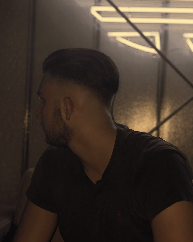 Sauberer Fade mit Bart im Neonlicht